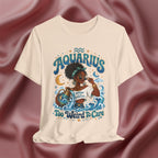 Cream T-shirt Black t-shirt with 'Aquarius Too Weird To Care' design featuring a black woman wearing a t-shirt with the text 'different is my superpower' on a pink fabric background