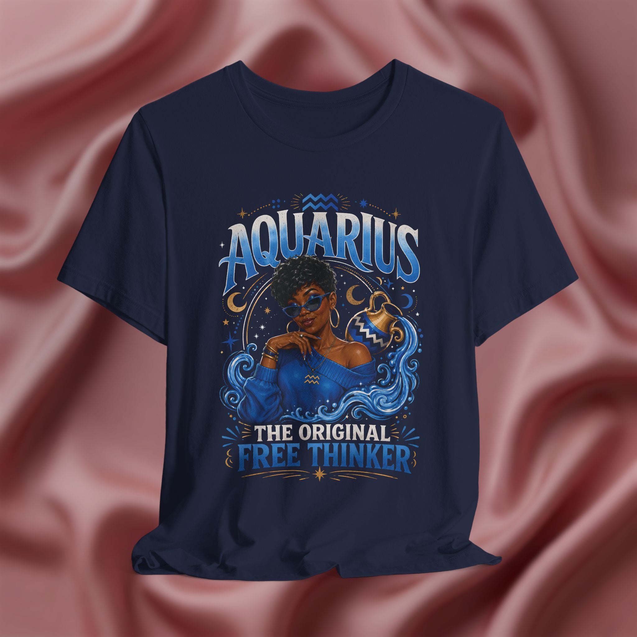 Navy blue t-shirt with Aquarius design featuring a black woman and text 'The original free thinker' on a pink fabric background