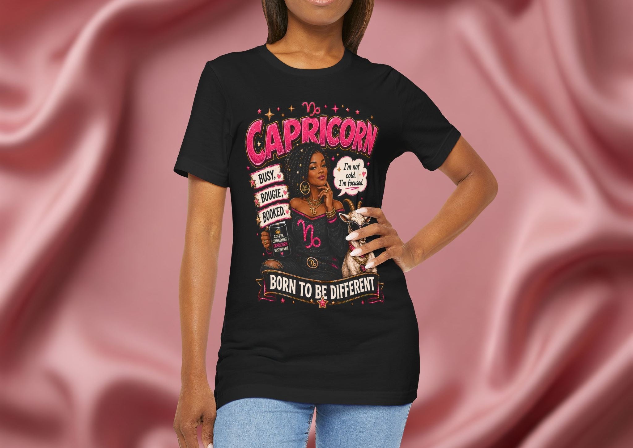 Woman wearing a black t-shirt with Capricorn design on a pink fabric background