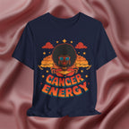 Navy blue t-shirt with a graphic design of a person with an afro and 'Cancer Energy' text on a pink fabric background.