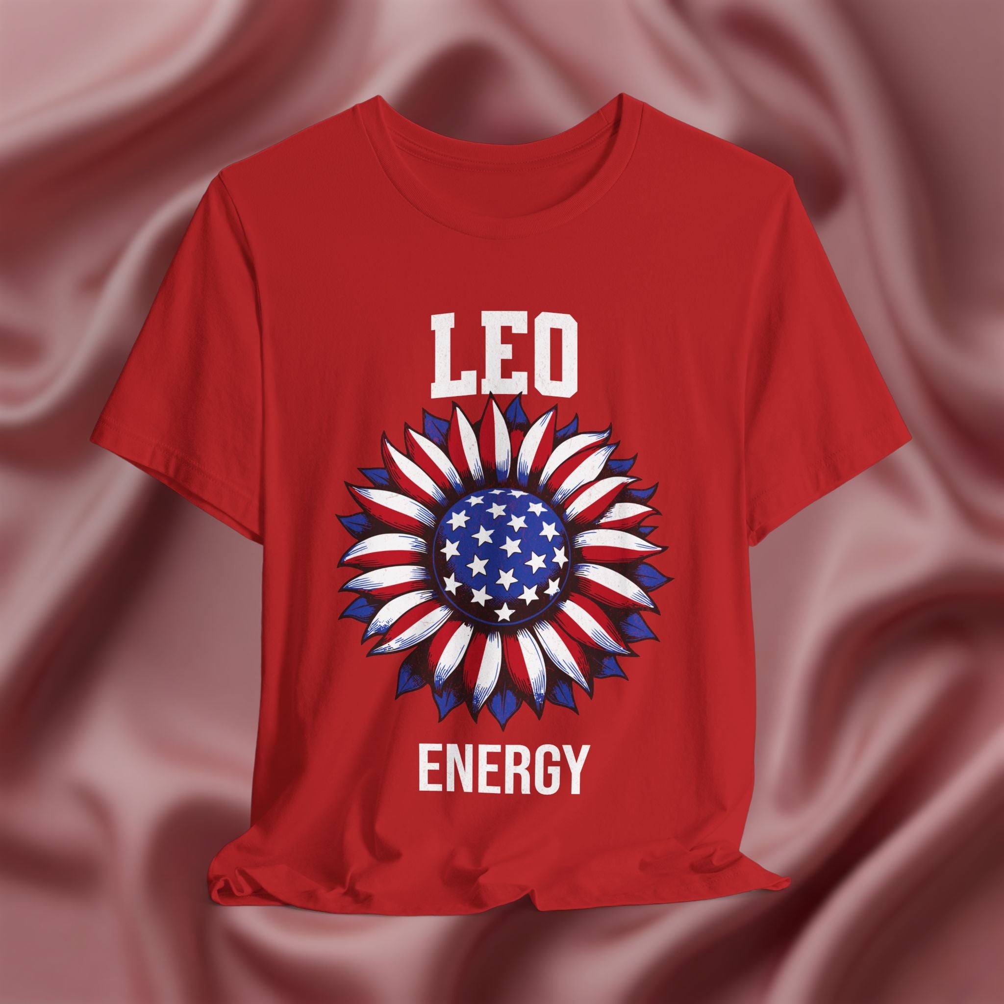 Red t-shirt with American flag sunflower and 'LEO ENERGY' text on a textured pink background