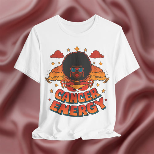 White t-shirt with a graphic design of a person with an afro and 'Cancer Energy' text on a maroon fabric background.