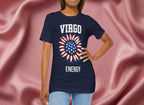 Person wearing a navy blue t-shirt with American flag sunflower and 'VIRGO ENERGY' text on a textured pink background