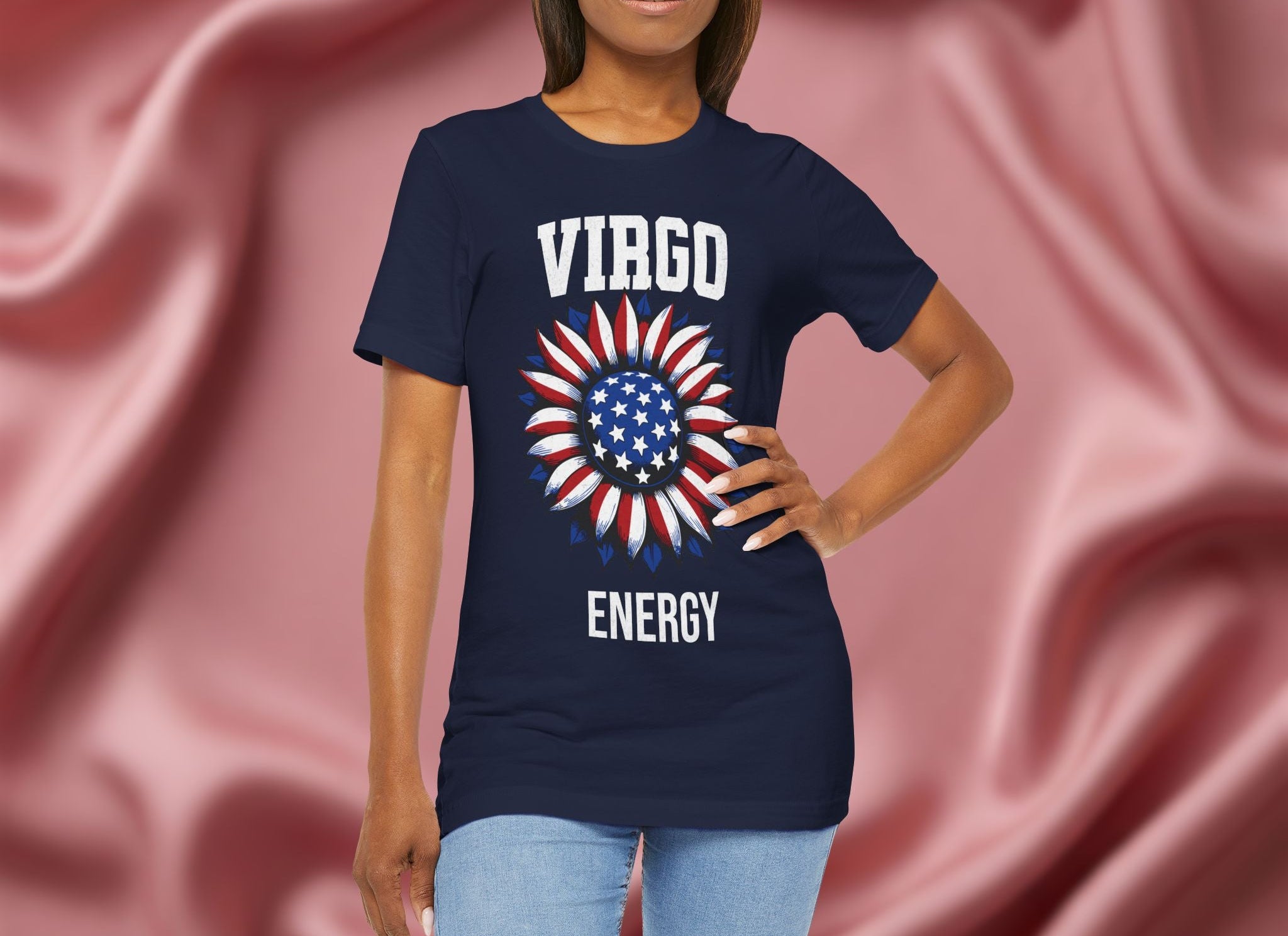 Person wearing a navy blue t-shirt with American flag sunflower and 'VIRGO ENERGY' text on a textured pink background