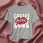 Gray t-shirt with 'GEMINI Love' and lips design on a pink fabric background