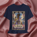 Navy blue t-shirt with Libra zodiac design on a pink fabric background