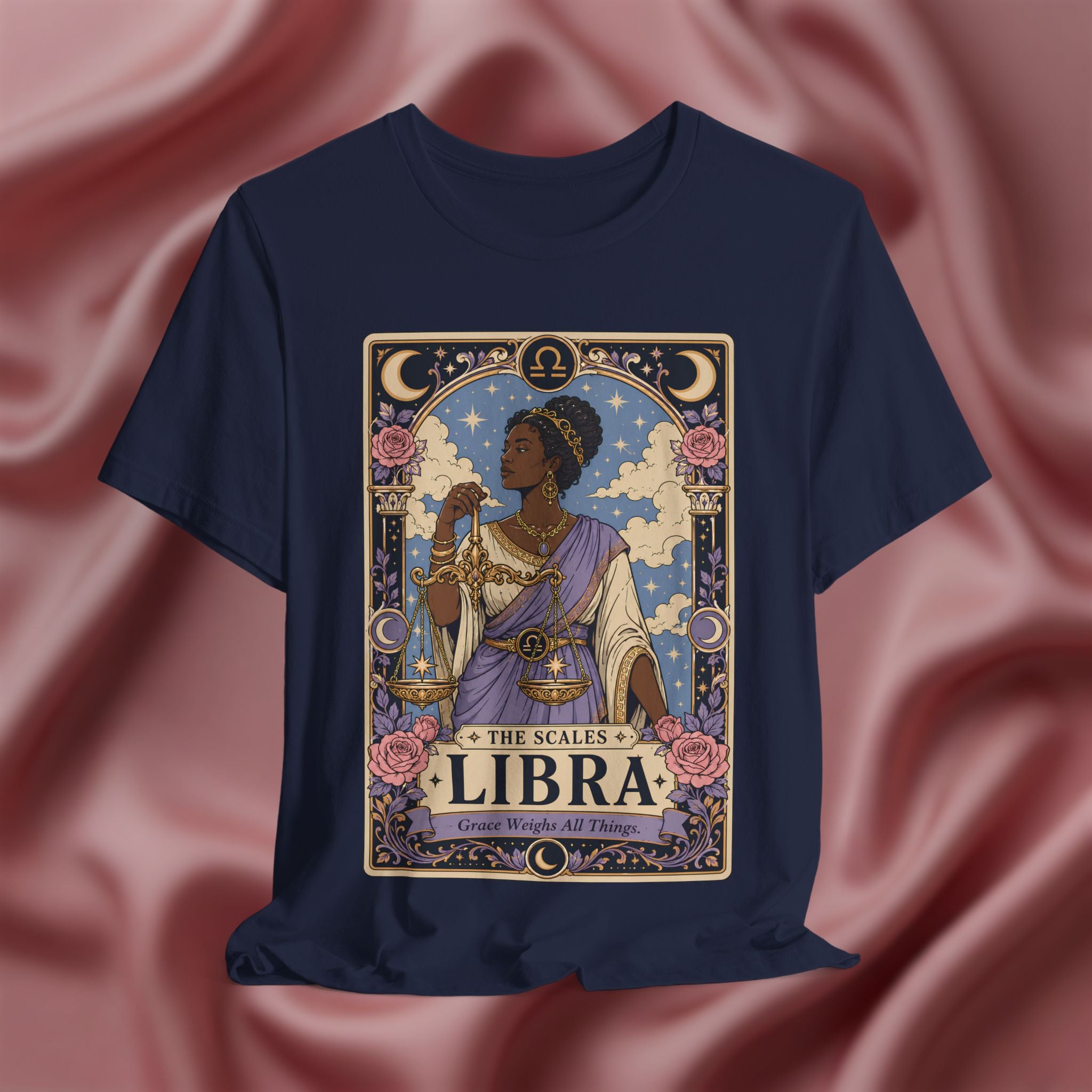 Navy blue t-shirt with Libra zodiac design on a pink fabric background