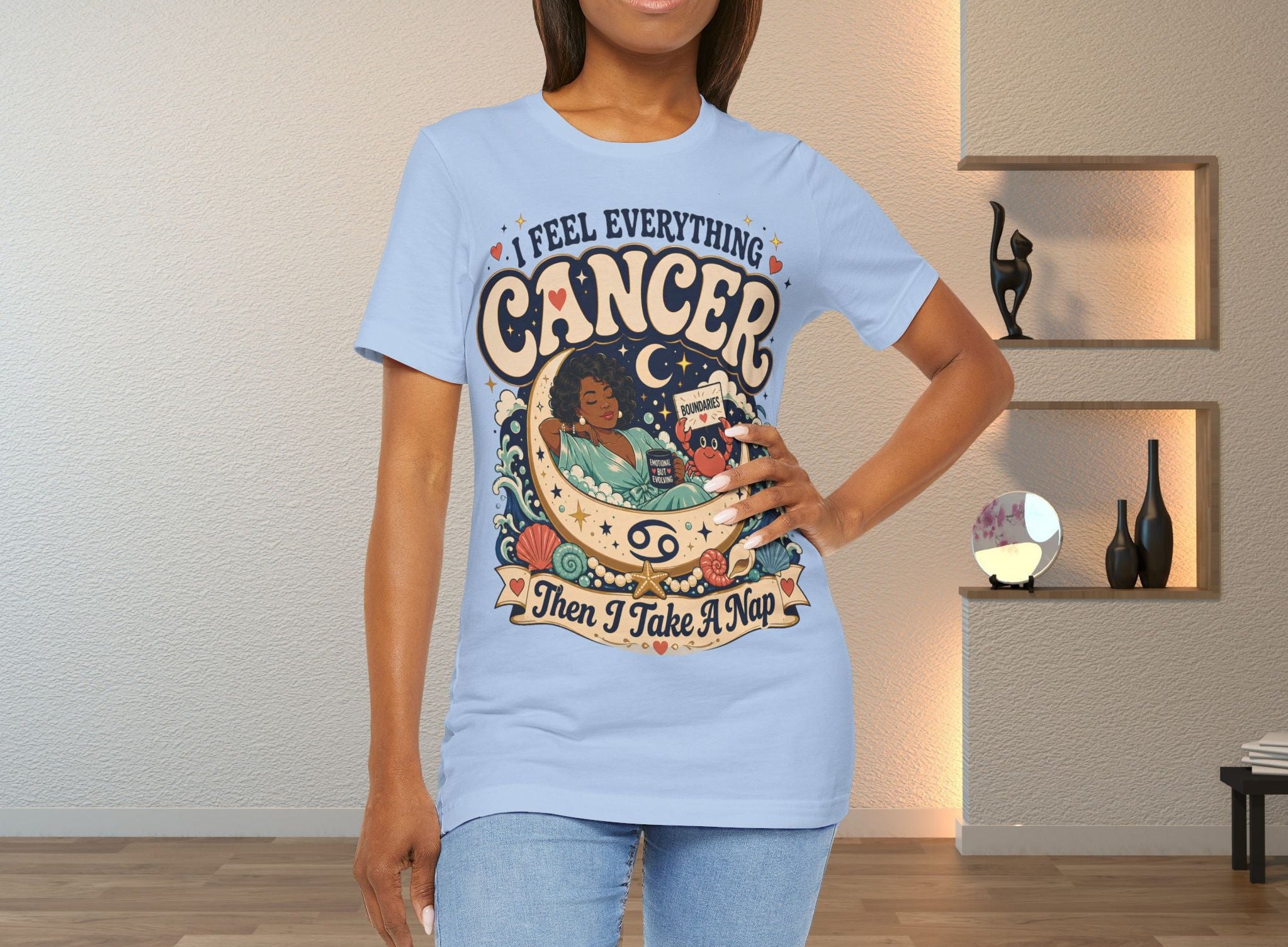 Woman wearing a light blue t-shirt with 'I Feel Everything, Cancer, Then I Take a Nap' design
