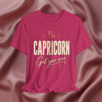 Pink t-shirt with 'Capricorn Get you one' text on a pink fabric background
