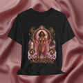 Black t-shirt with 'Aquarius' design featuring a woman in a pink dress on a pink fabric background