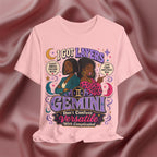 Pink t-shirt with Gemini zodiac design on a maroon fabric background
