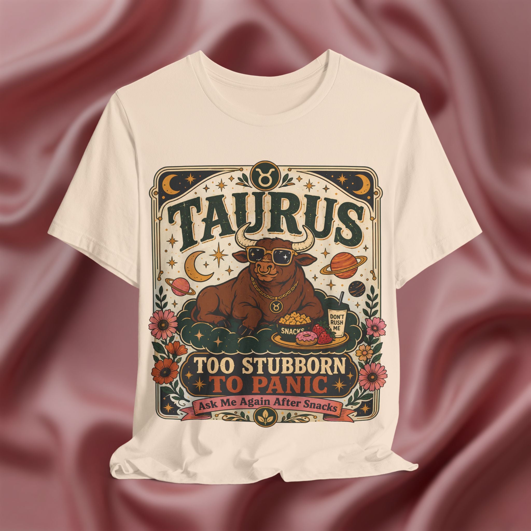 Soft cream T-shirt with Taurus zodiac design on a textured red background