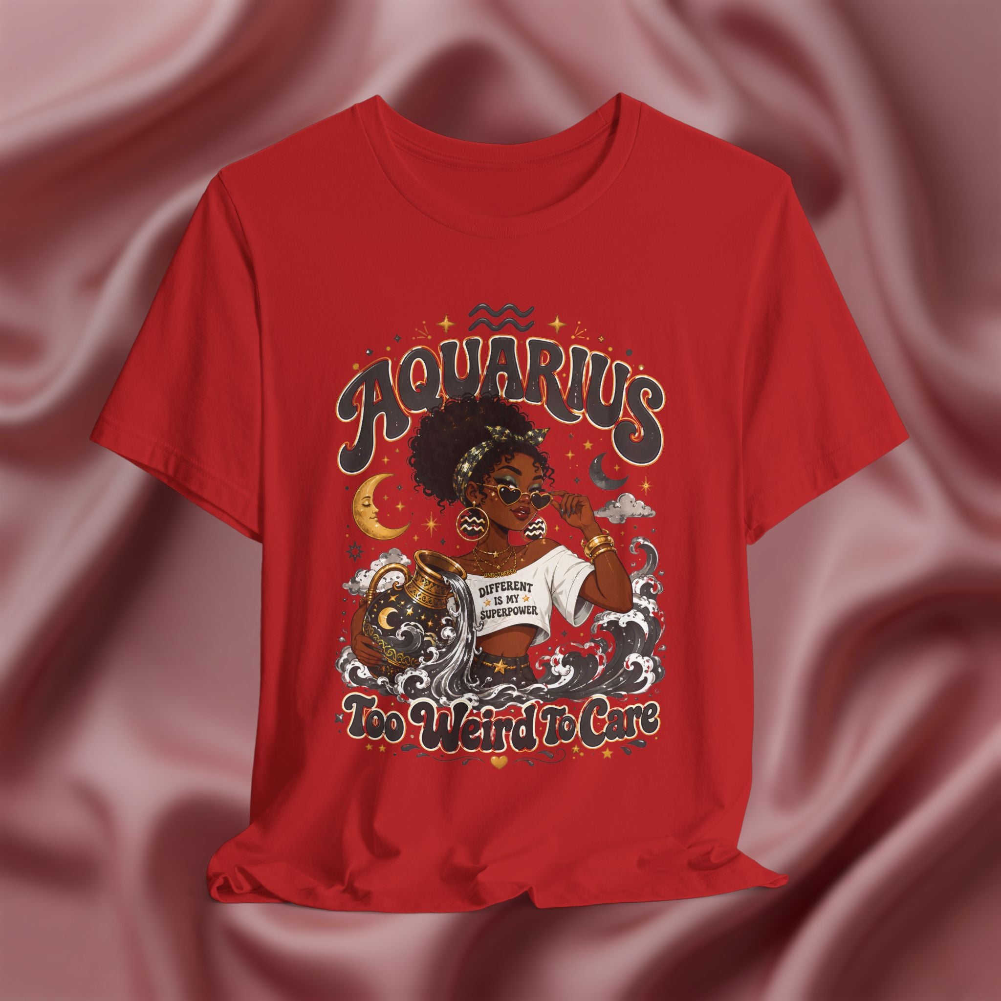 Red t-shirt with 'Aquarius Too Weird To Care' design featuring a black woman wearing a t-shirt with the text 'different is my superpower' on a pink fabric background
