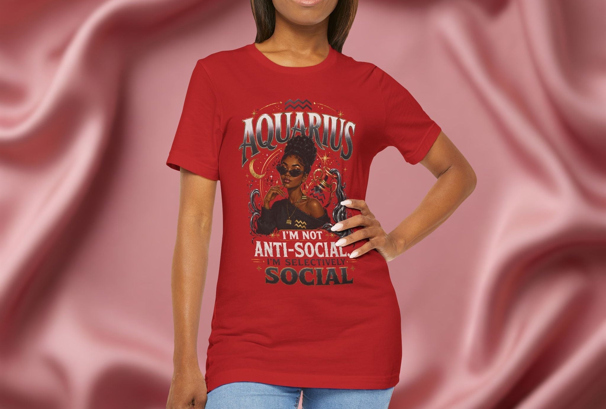 Person wearing a red t-shirt with Aquarius design featuring a black woman and text 'Aquarius I'm not anti-social I'm selectively social' on a pink fabric background