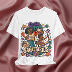 White t-shirt with colorful Sagittarius-themed design on a maroon fabric background