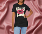 Woman wearing a black t-shirt with 'GEMINI Love' and lips design on a pink fabric background
