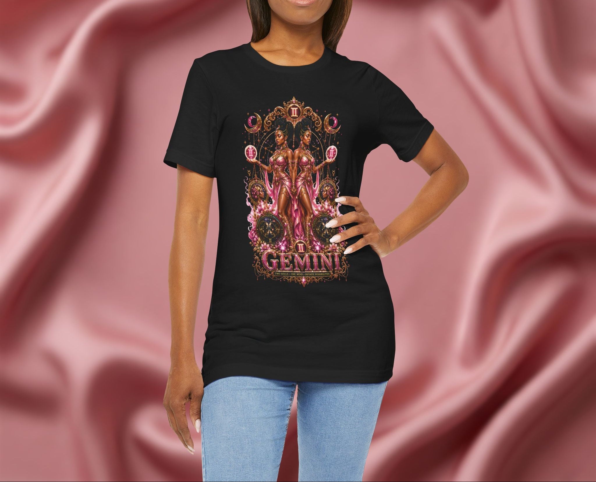 Woman wearing a black t-shirt with Gemini zodiac design on a pink fabric background