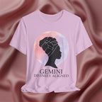 Lilac t-shirt with a silhouette of a woman and 'Gemini Divinely Aligned' text on a pink fabric background
