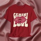 Red t-shirt with 'GEMINI Love' and lips design on a pink fabric background