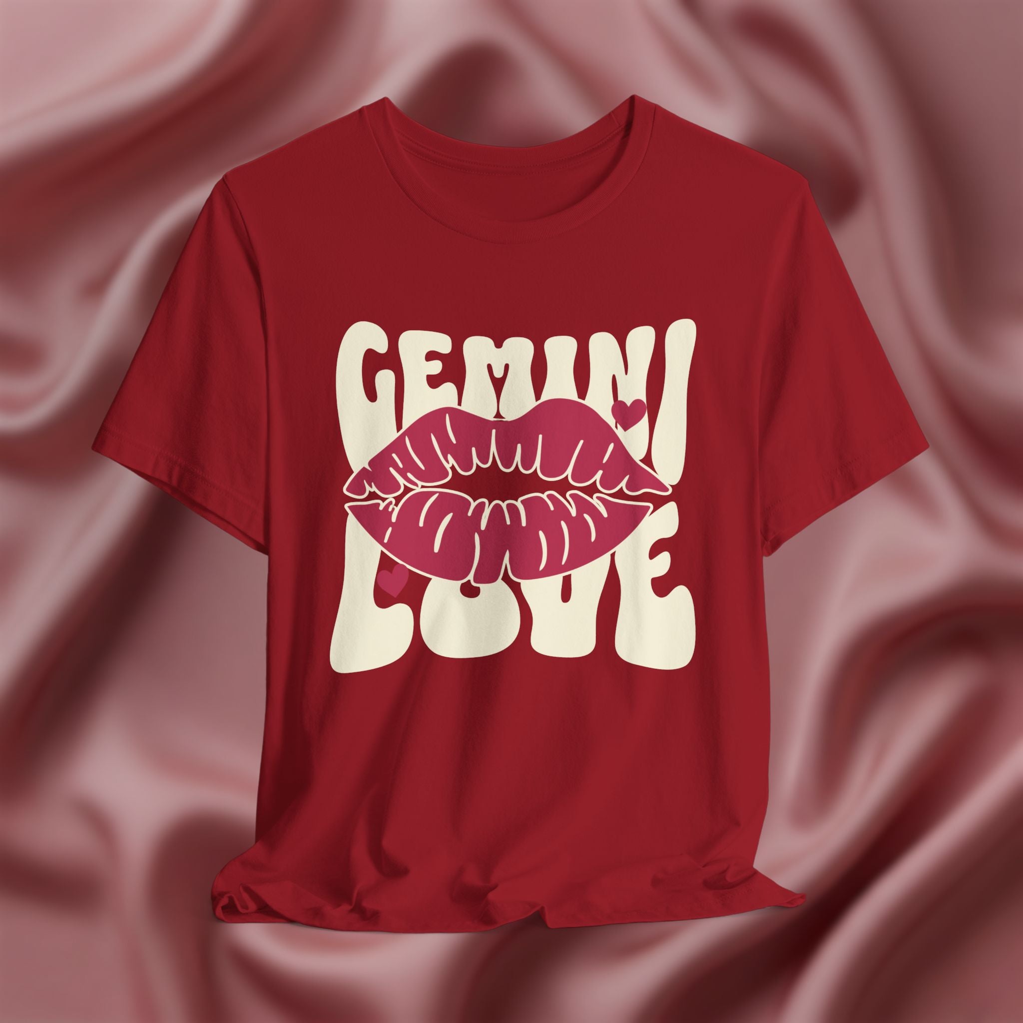 Red t-shirt with 'GEMINI Love' and lips design on a pink fabric background