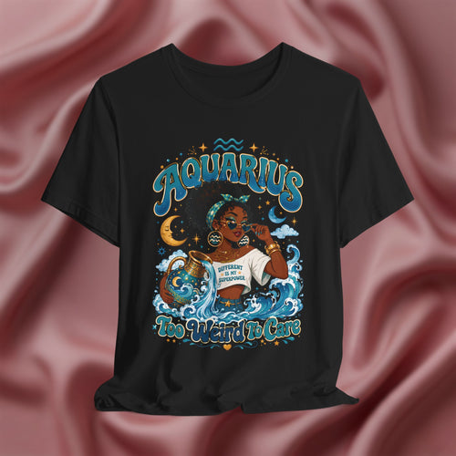 Black t-shirt with 'Aquarius Too Weird To Care' design featuring a black woman wearing a t-shirt with the text 'different is my superpower' on a pink fabric background
