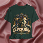 Green t-shirt with Capricorn zodiac design on a pink fabric background