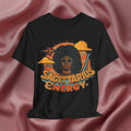 Black t-shirt with 'Sagittarius Energy' design on a pink fabric background
