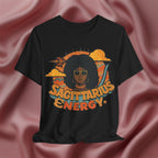 Black t-shirt with 'Sagittarius Energy' design on a pink fabric background