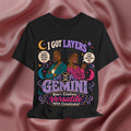 Black t-shirt with Gemini-themed design featuring two women on a pink fabric background