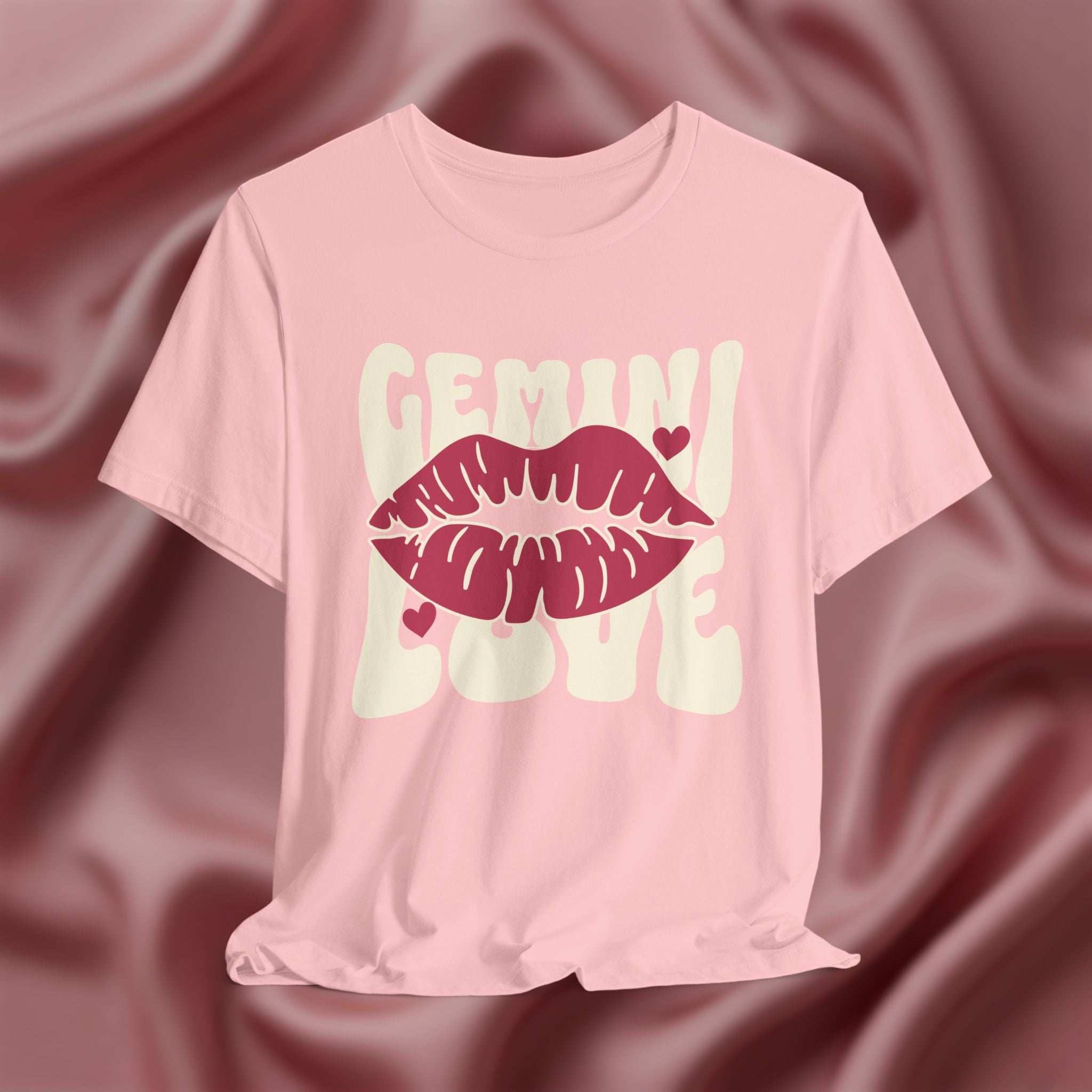 Pink t-shirt with 'GEMINI Love' and lips design on a pink fabric background
