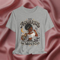Athletic Heather Gray t-shirt with 'Aquarius Too Weird To Care' design featuring a black woman wearing a t-shirt with the text 'different is my superpower' on a pink fabric background