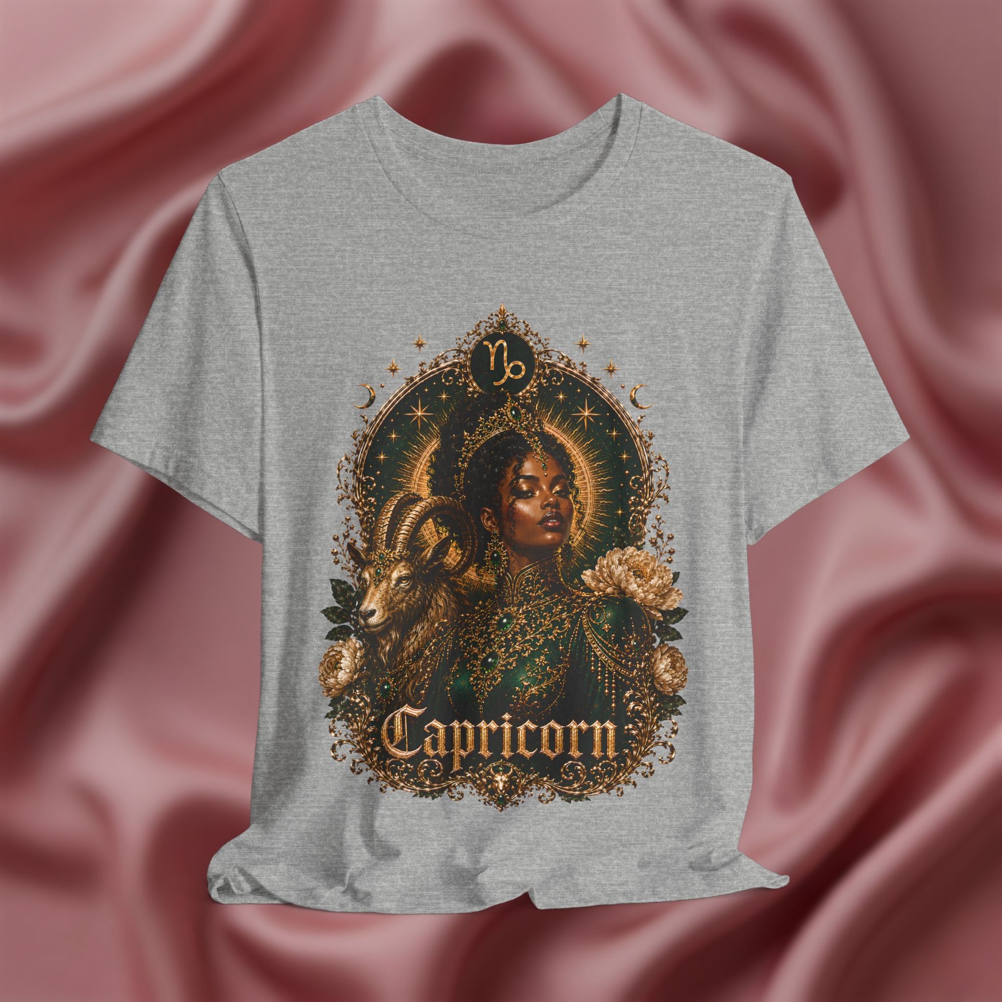 Gray t-shirt with Capricorn design on a pink fabric background