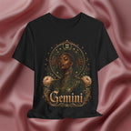 Black t-shirt with 'Gemini' design featuring a woman's face and floral elements on a pink fabric background.