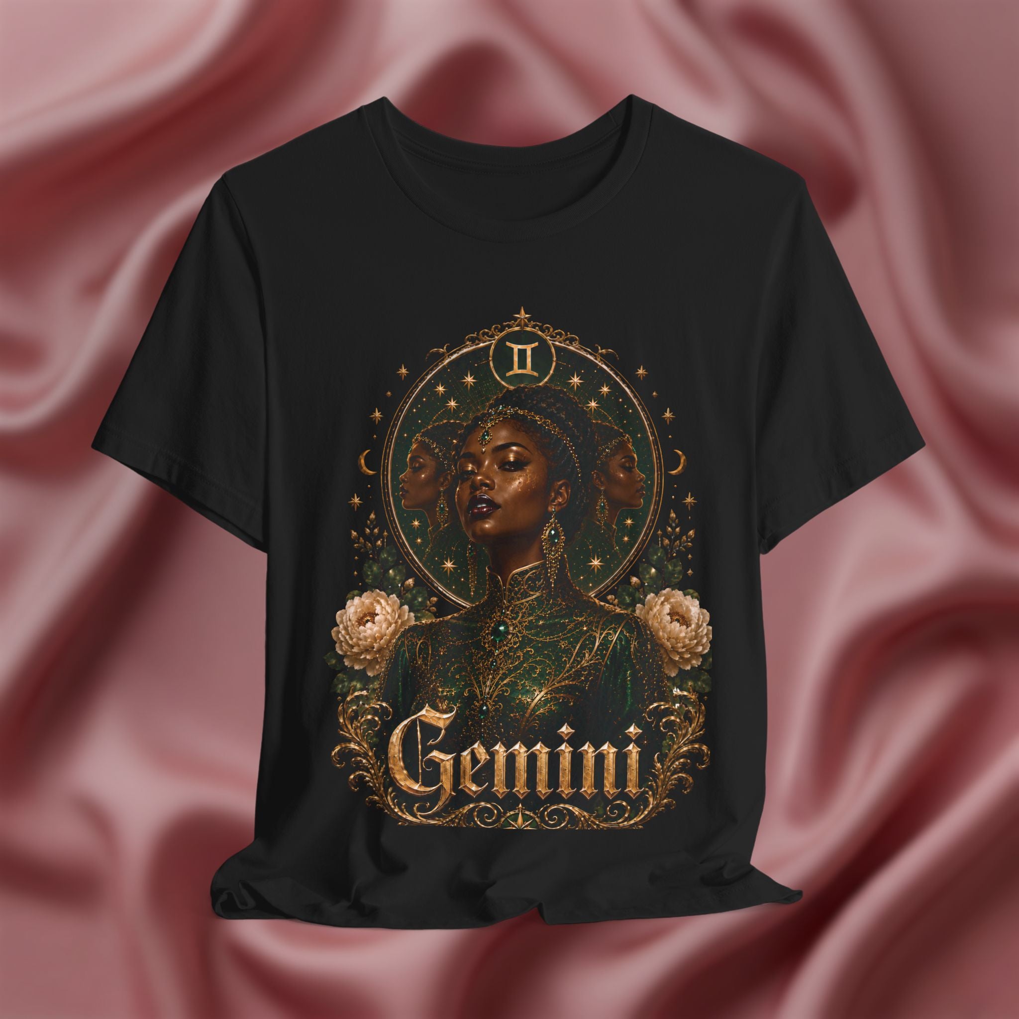 Black t-shirt with 'Gemini' design featuring a woman's face and floral elements on a pink fabric background.