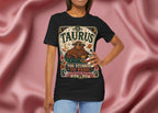 Person wearing a black t-shirt with Taurus zodiac design against a pink fabric background