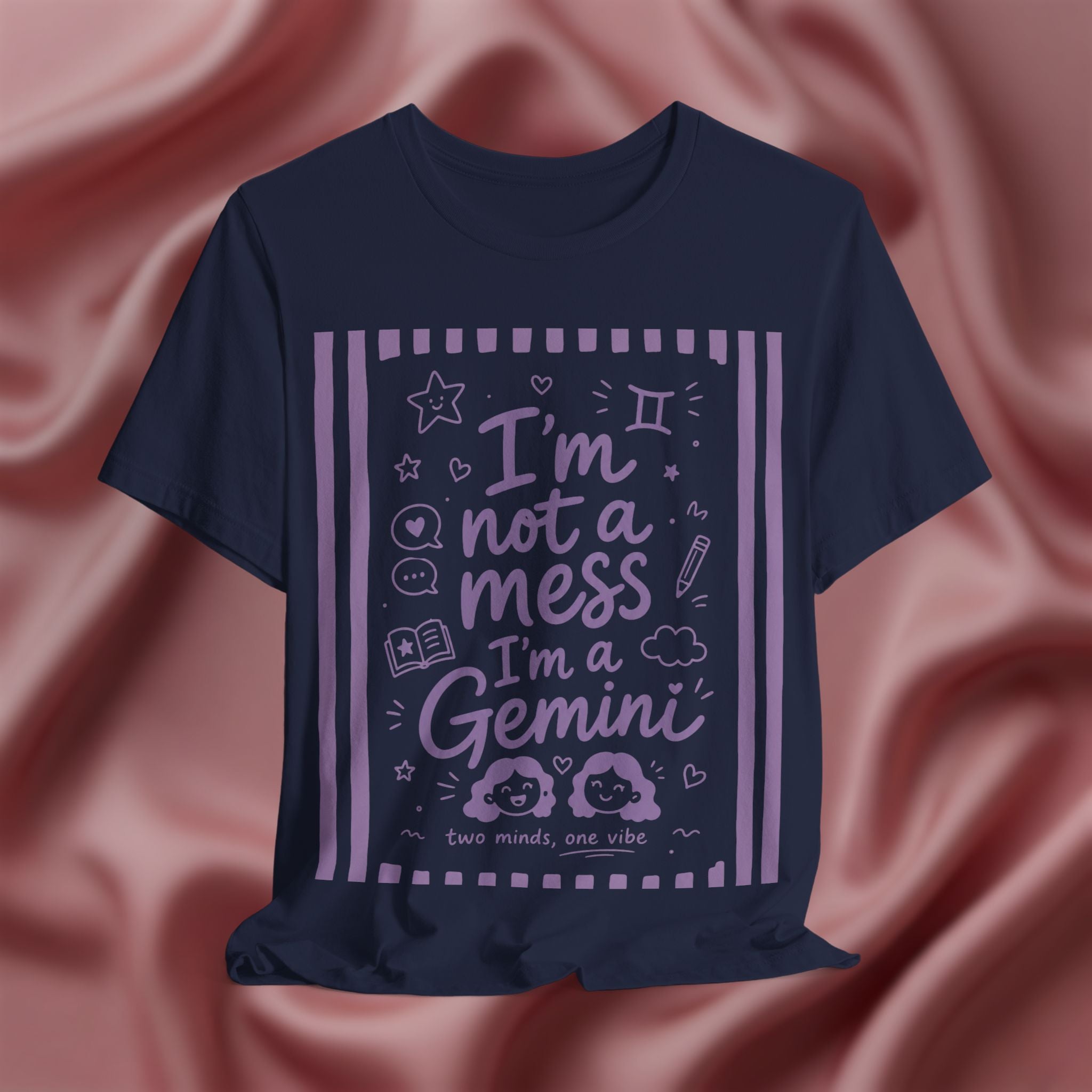 Navy blue t-shirt with purple text 'I'm not a mess I'm a Gemini and graphics on a pink fabric background