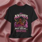 Black t-shirt with Aquarius design featuring a black woman and text 'Aquarius I'm not anti-social I'm selectively social' on a pink fabric background