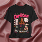 Black t-shirt with Capricorn zodiac design featuring a woman and goat on a pink fabric background