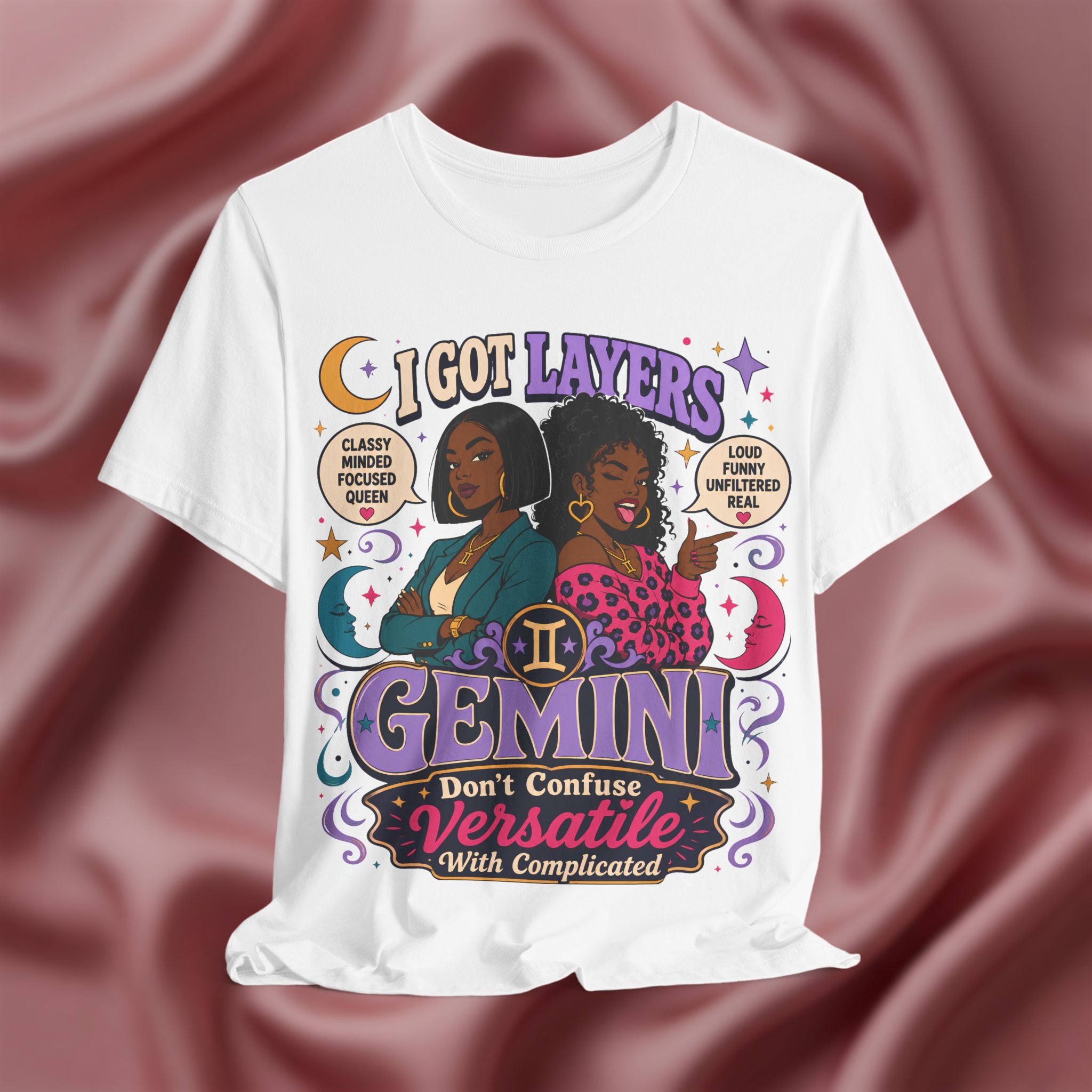 White t-shirt with Gemini zodiac design featuring two women on a maroon fabric background