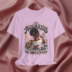 Lilac t-shirt with 'Aquarius Too Weird To Care' design featuring a black woman wearing a t-shirt with the text 'different is my superpower' on a pink fabric background