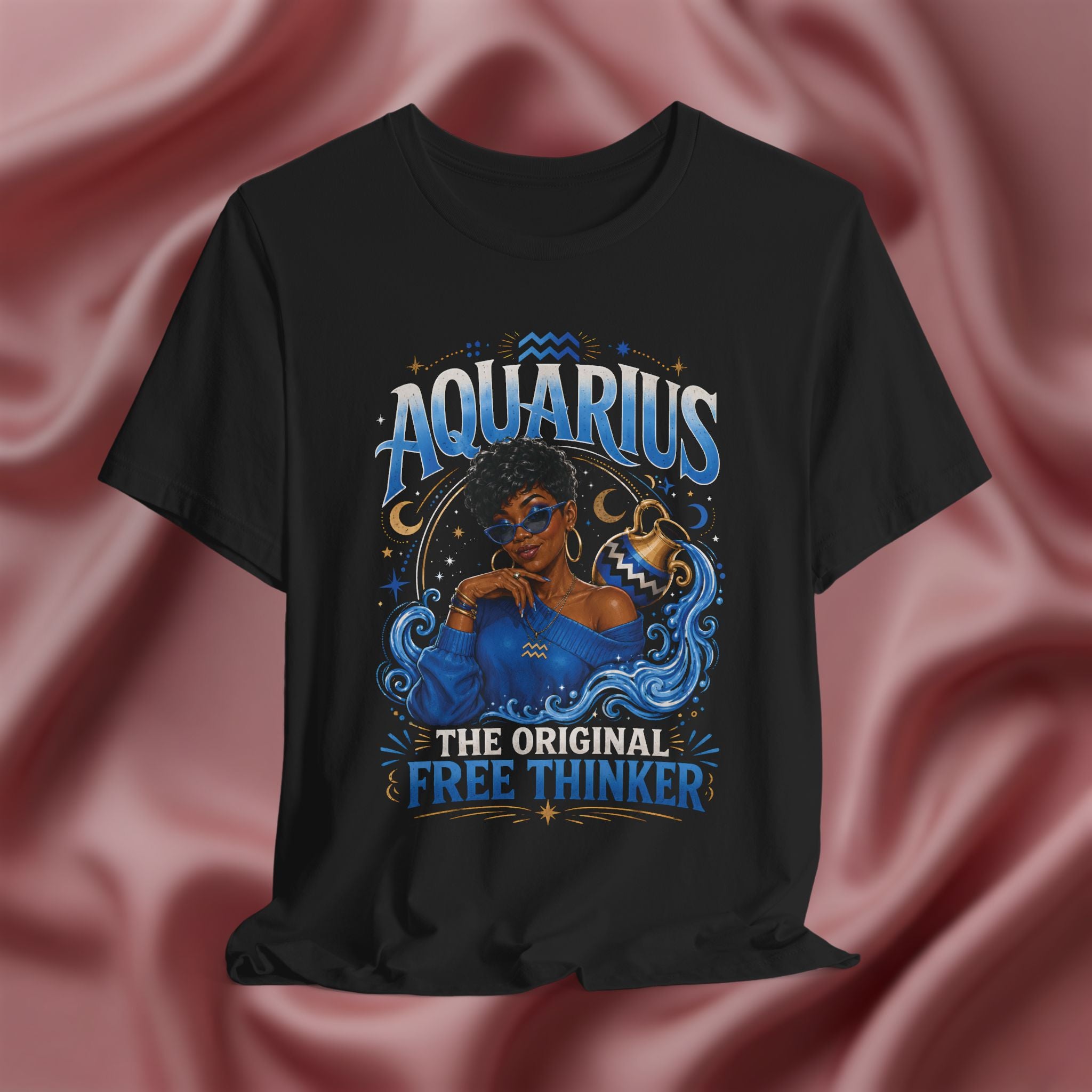Black t-shirt with Aquarius design featuring a black woman and text 'The original free thinker' on a pink fabric background
