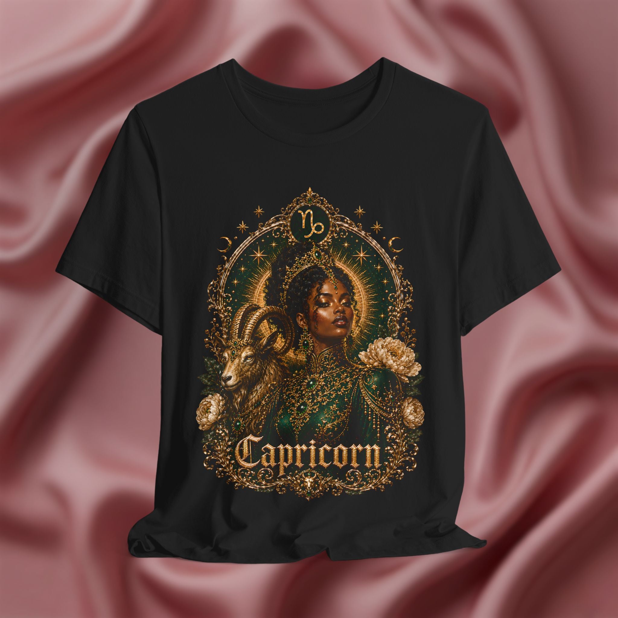 Black t-shirt with Capricorn zodiac design on a pink fabric background