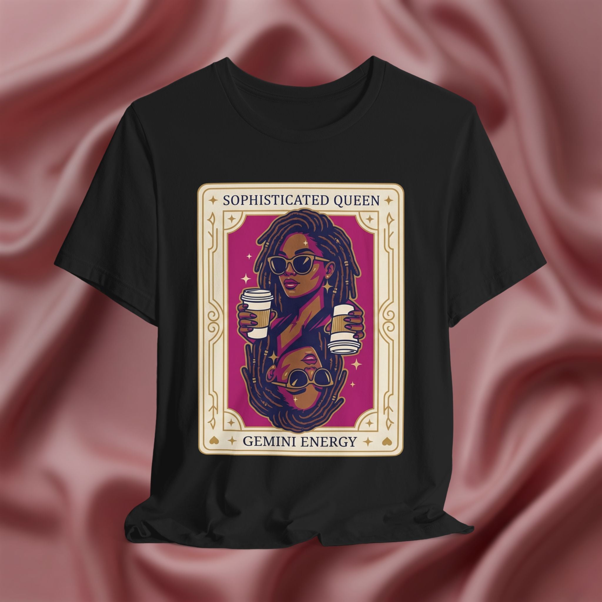 Sophisticated Queen Gemini Energy Black t-shirt with a graphic design of a woman holding coffee cups on a pink fabric background