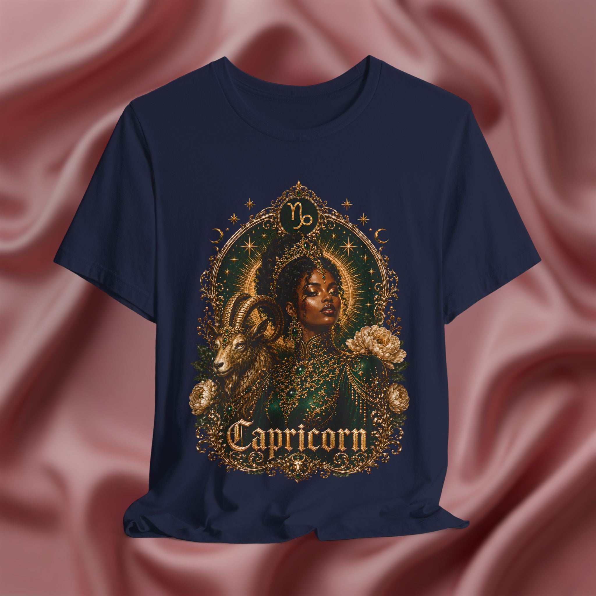 Navy blue t-shirt with Capricorn design on a pink fabric background