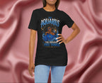Woman wearing a black t-shirt with Aquarius design featuring a black woman and text 'The original free thinker' on a pink fabric background