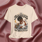 Cream t-shirt with 'Aquarius Too Weird To Care' design featuring a black woman wearing a t-shirt with the text 'different is my superpower' on a pink fabric background