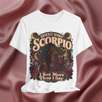 White t-shirt with Scorpio zodiac design on a maroon fabric background