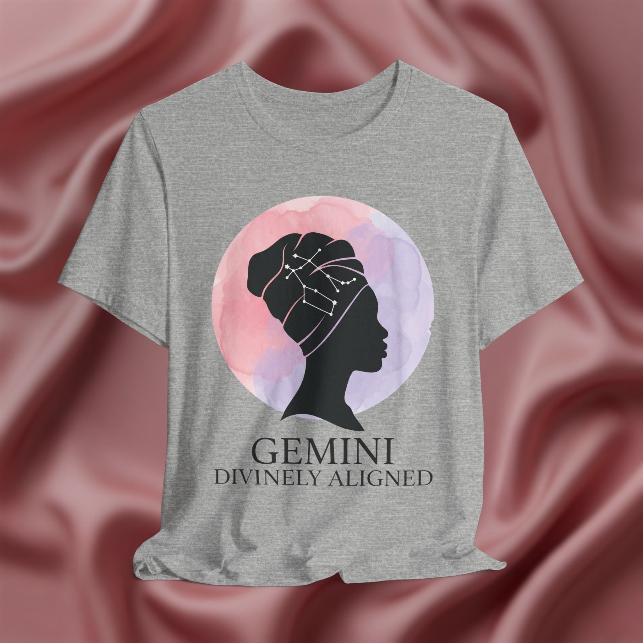 Athletic Heather t-shirt with a silhouette of a woman and 'Gemini Divinely Aligned' text on a pink fabric background