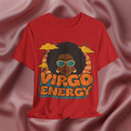 A red short-sleeve graphic t-shirt featuring a retro-style illustration of a woman with an afro, sunglasses, and the text 'VIRGO ENERGY' in orange and teal, displayed against a draped pink satin background.