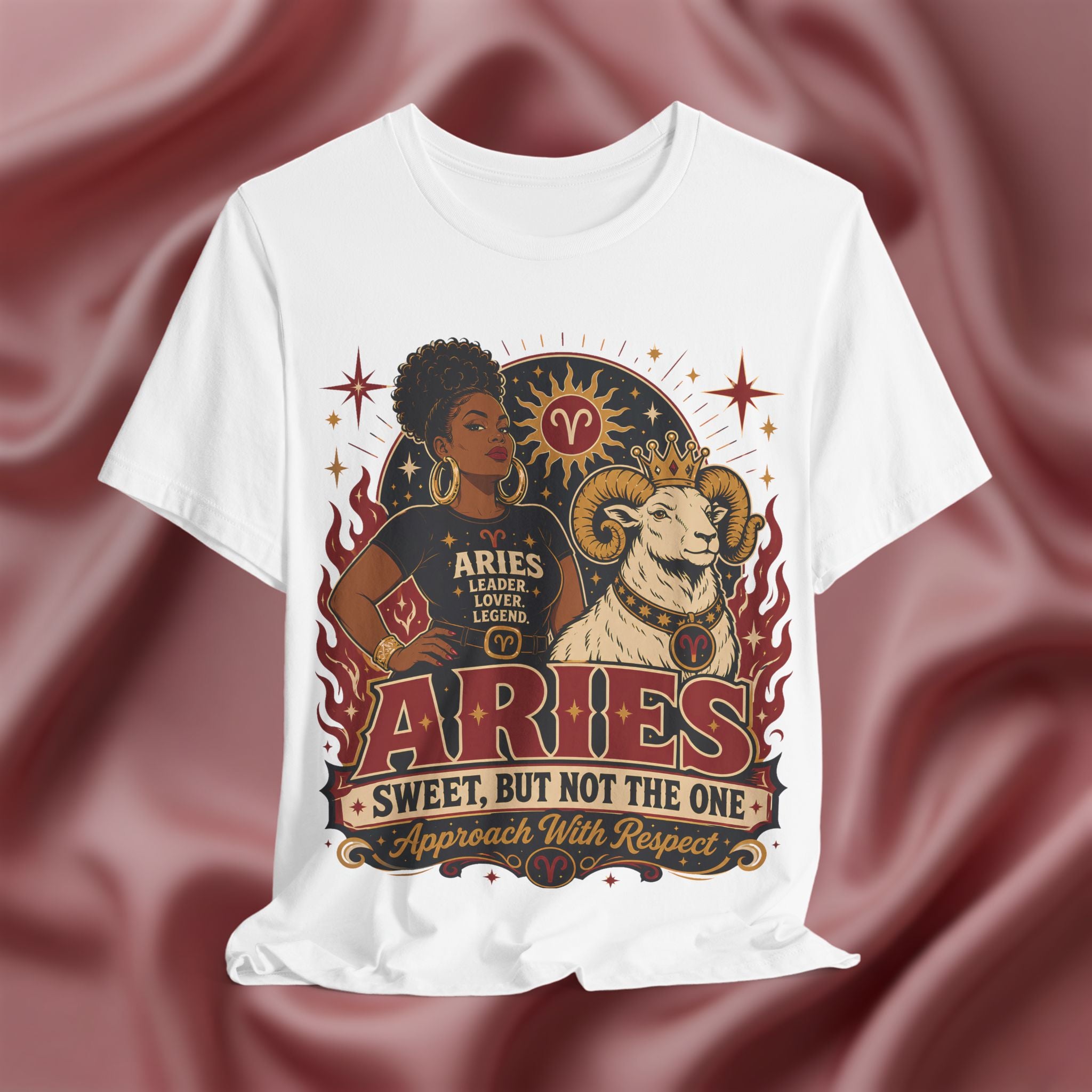 White t-shirt with Aries zodiac design on a maroon fabric background